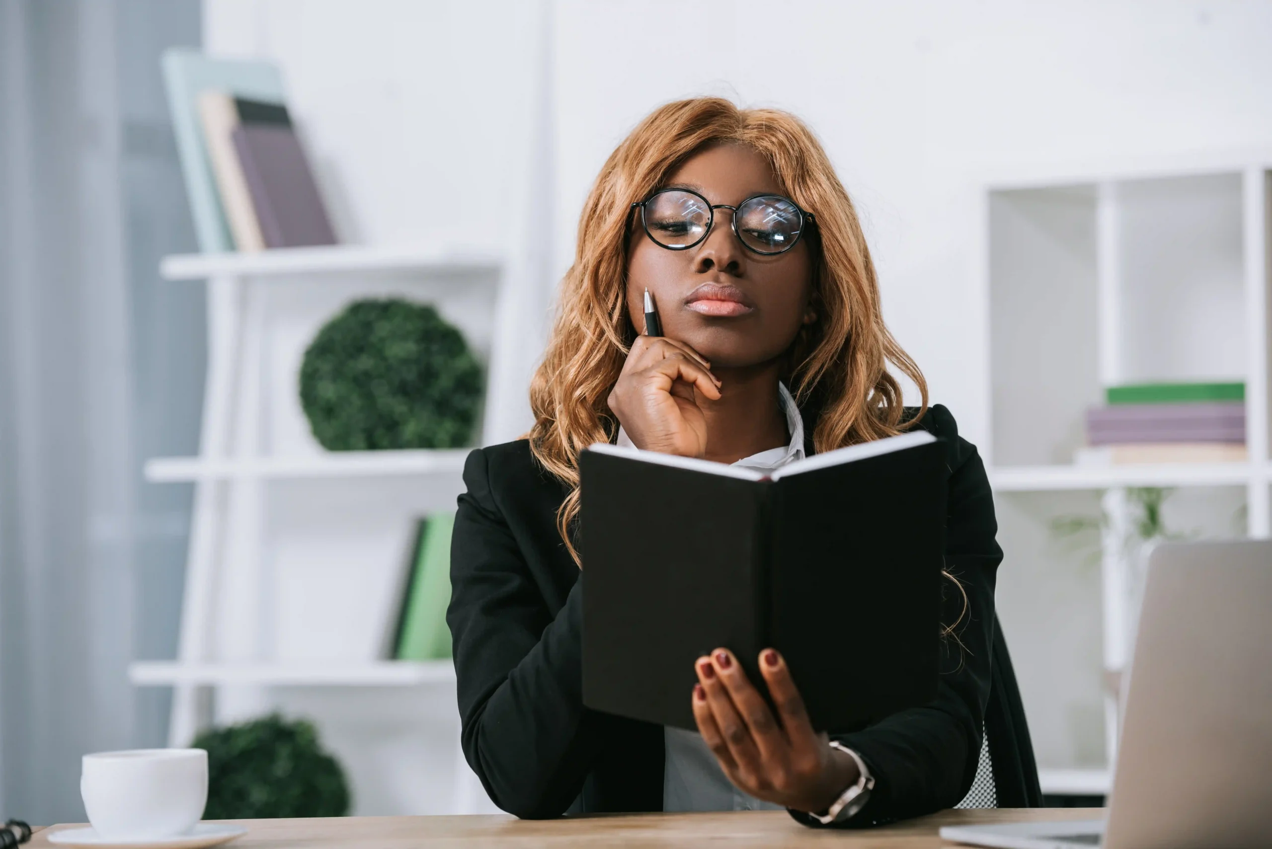 thoughtful businesswoman with a book