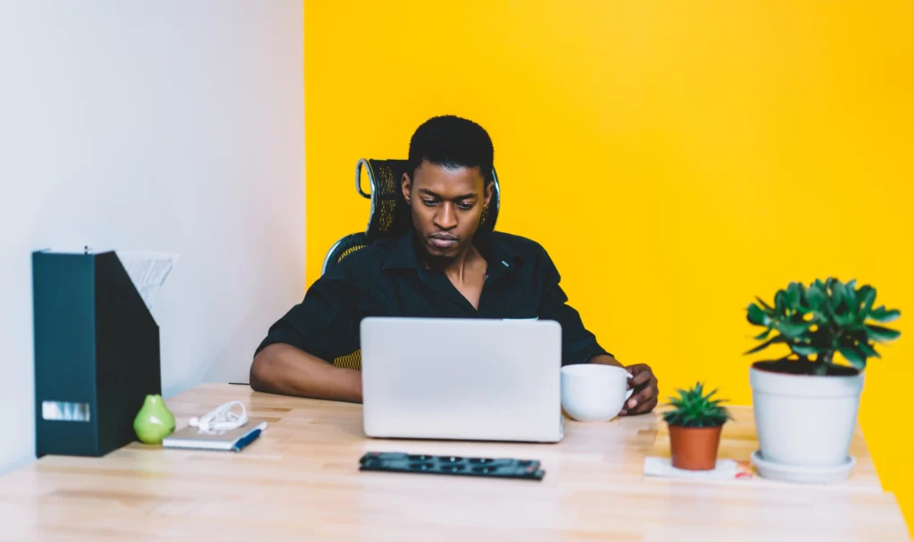 man reading a blog on a laptop in office