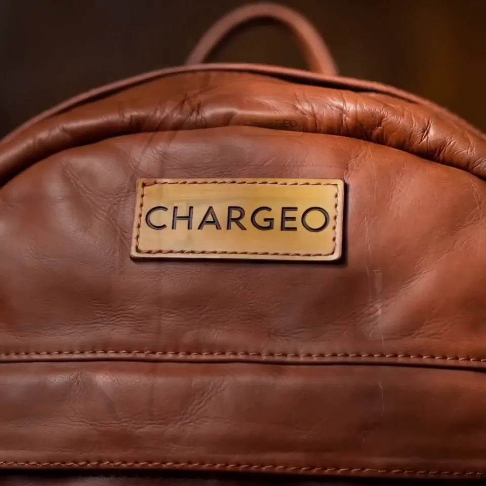 AI product video frame of a CHARGEO leather backpack